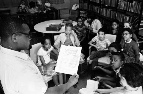 Teacher holding a "Freedom Diploma" at a Freedom School, 1963