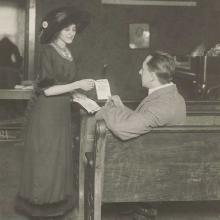 Suffragist distributing flyer, c. 1915